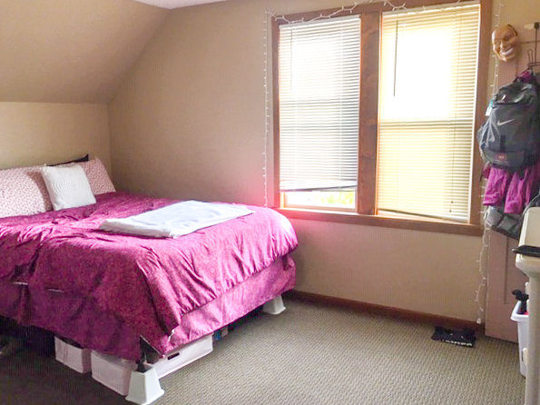 pink bed in bedroom of rental